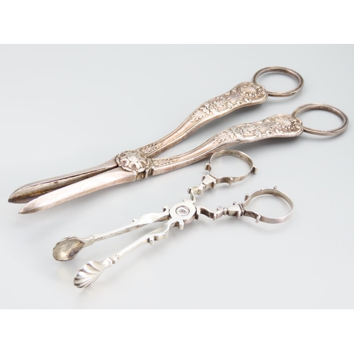 396 - Pair of Silver Sugar Nips Attractively Detailed with Scallop Shell Motif Wells 12cm Long and Silver ... 