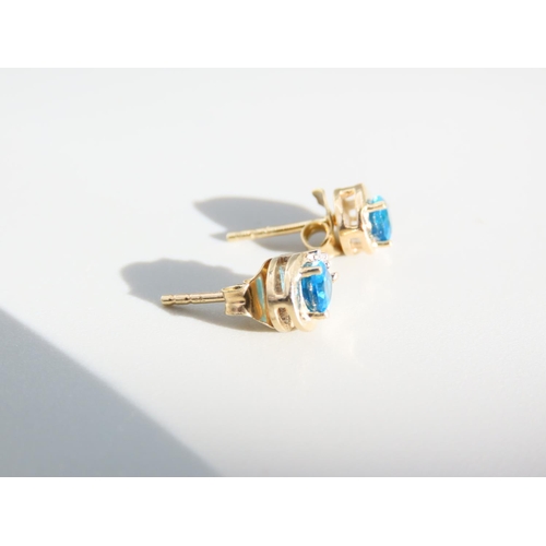 414 - Pair of Blue Topaz and Diamond Set Ladies Earrings Mounted in 9 Carat Yellow Gold