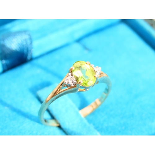 473 - Peridot and Diamond Ladies Centre Stone Ring Mounted on 9 Carat Yellow Gold Band Ring Size O