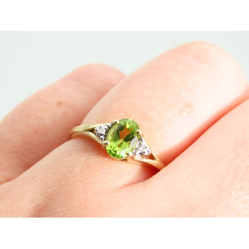 473 - Peridot and Diamond Ladies Centre Stone Ring Mounted on 9 Carat Yellow Gold Band Ring Size O