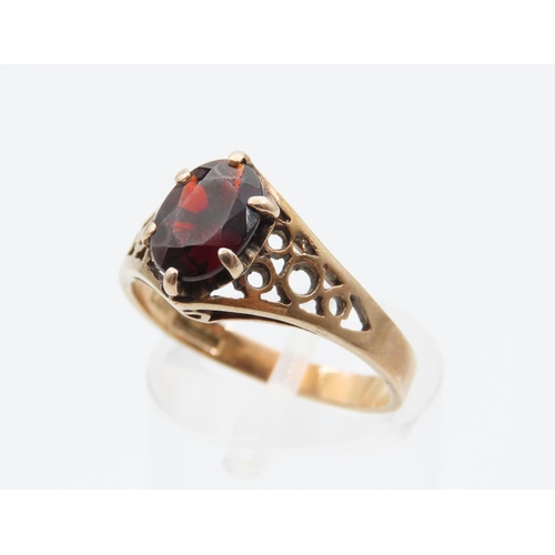 1078 - Red Garnet Ladies Centre Stone Ring Claw Set Mounted on 9 Carat Yellow Gold Band Ring Size N