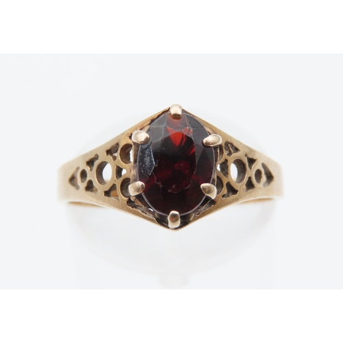 1078 - Red Garnet Ladies Centre Stone Ring Claw Set Mounted on 9 Carat Yellow Gold Band Ring Size N