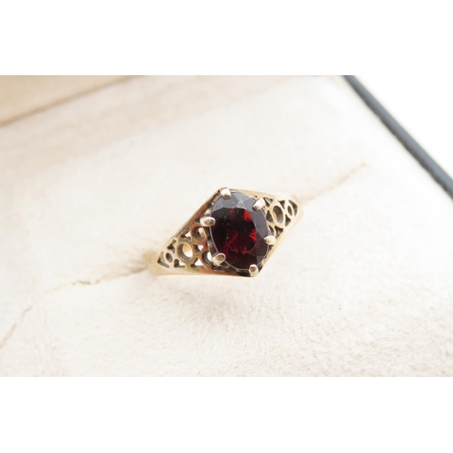 1078 - Red Garnet Ladies Centre Stone Ring Claw Set Mounted on 9 Carat Yellow Gold Band Ring Size N