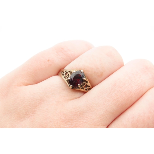 1078 - Red Garnet Ladies Centre Stone Ring Claw Set Mounted on 9 Carat Yellow Gold Band Ring Size N