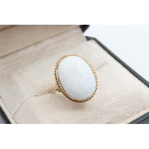 1079 - Opal center Stone Ring Mounted on 9 Carat Gold Band Ring Size M and a Half