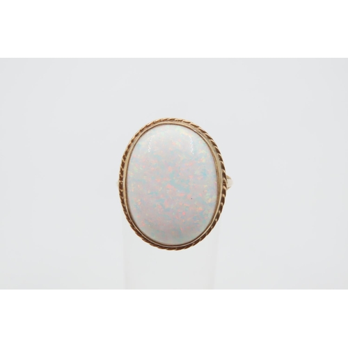 1079 - Opal center Stone Ring Mounted on 9 Carat Gold Band Ring Size M and a Half