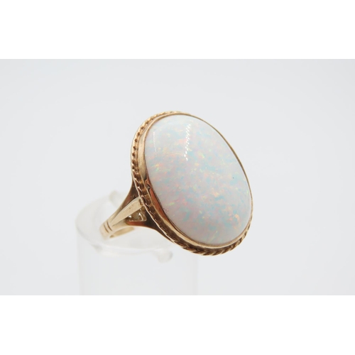 1079 - Opal center Stone Ring Mounted on 9 Carat Gold Band Ring Size M and a Half