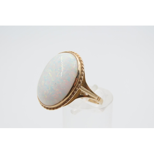 1079 - Opal center Stone Ring Mounted on 9 Carat Gold Band Ring Size M and a Half