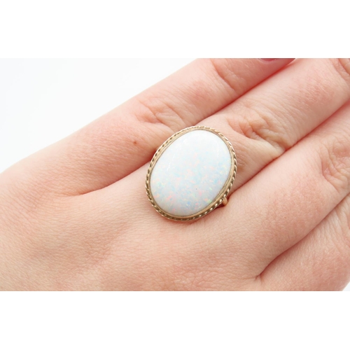 1079 - Opal center Stone Ring Mounted on 9 Carat Gold Band Ring Size M and a Half