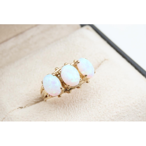 1091 - Opal Three Stone Ring Mounted on 9 Carat Yellow Gold Band Ring Size O and a Half