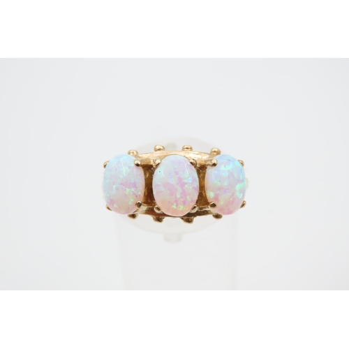 1091 - Opal Three Stone Ring Mounted on 9 Carat Yellow Gold Band Ring Size O and a Half