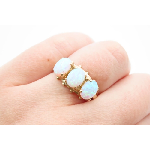 1091 - Opal Three Stone Ring Mounted on 9 Carat Yellow Gold Band Ring Size O and a Half