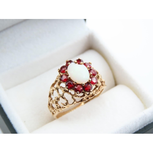 1100 - Opal and Red Garnet Cluster Ring Mounted on Detailed Yellow Gold Band Ring Size O