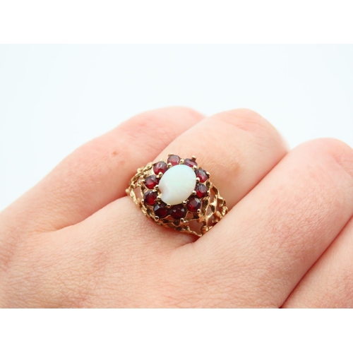 1100 - Opal and Red Garnet Cluster Ring Mounted on Detailed Yellow Gold Band Ring Size O