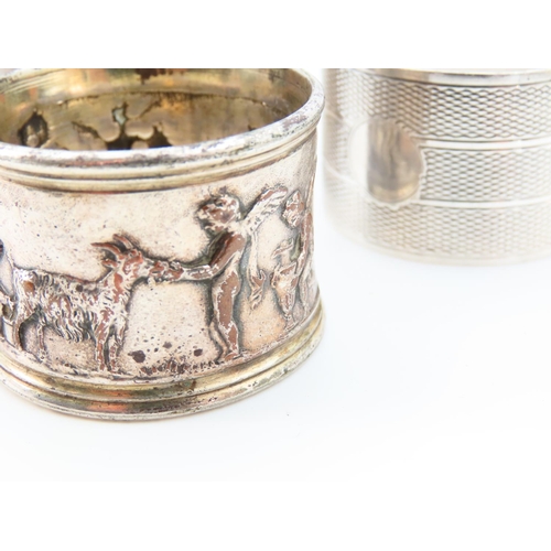 1162 - Three Silver Napkin Rings One with Cherub Motif Detailed