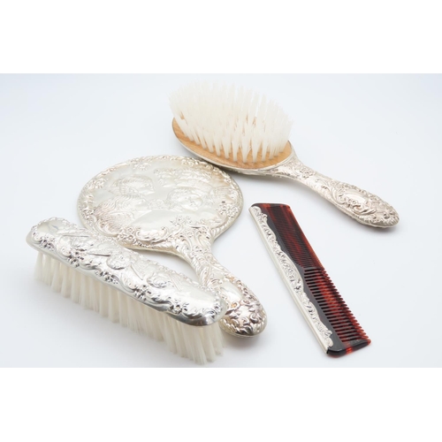 1195 - Four Piece Silver Mounted Hair Brushing Set with Hand Held Mirror Cherub Motif Decoration Throughout