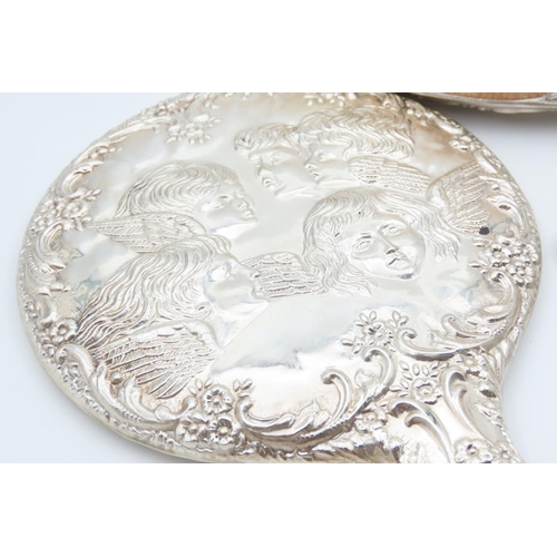 1195 - Four Piece Silver Mounted Hair Brushing Set with Hand Held Mirror Cherub Motif Decoration Throughout