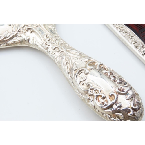 1195 - Four Piece Silver Mounted Hair Brushing Set with Hand Held Mirror Cherub Motif Decoration Throughout