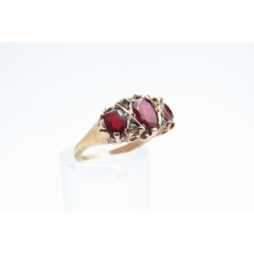 1219 - Garnet Three Stone Ring Mounted on 9 Carat Yellow Gold Band Ring Size M