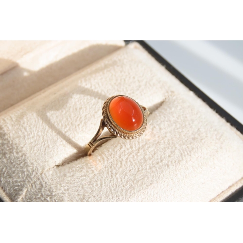 1325 - Cabochon Oval Cut Red Gemstone Ring Mounted on 9 Carat Yellow Gold Band Basset Set Ring Size O