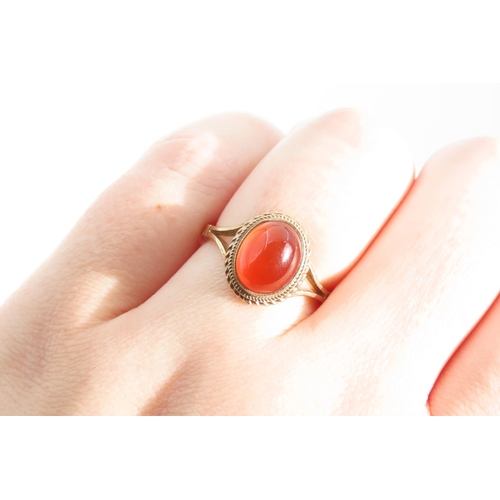 1325 - Cabochon Oval Cut Red Gemstone Ring Mounted on 9 Carat Yellow Gold Band Basset Set Ring Size O