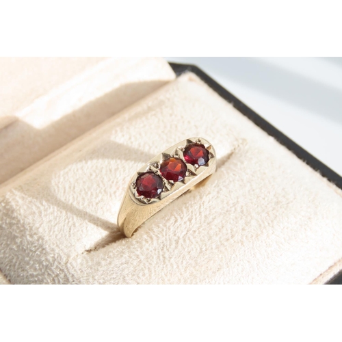 1329 - Three Stone Garnet Set Ladies Ring Mounted on 9 Carat Yellow Gold Band Ring Size S and a Half