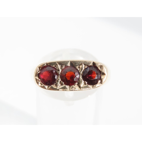 1329 - Three Stone Garnet Set Ladies Ring Mounted on 9 Carat Yellow Gold Band Ring Size S and a Half