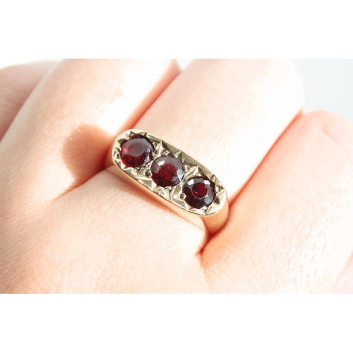 1329 - Three Stone Garnet Set Ladies Ring Mounted on 9 Carat Yellow Gold Band Ring Size S and a Half