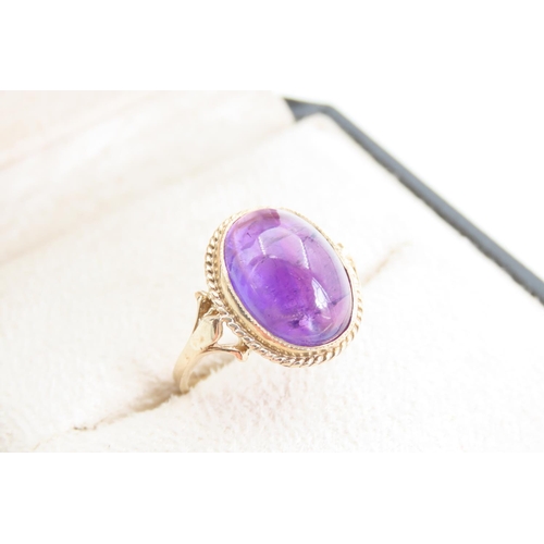 1360 - Cabochon Cut and Polished Oval Set Amethyst Centre Stone Ring Mounted on 9 Carat Yellow Gold Band Ri... 