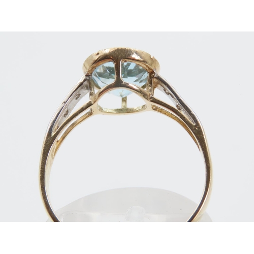 1389 - Blue Topaz and Diamond Set Ladies Ring Mounted on 9 Carat Yellow Gold Band Ring Size P