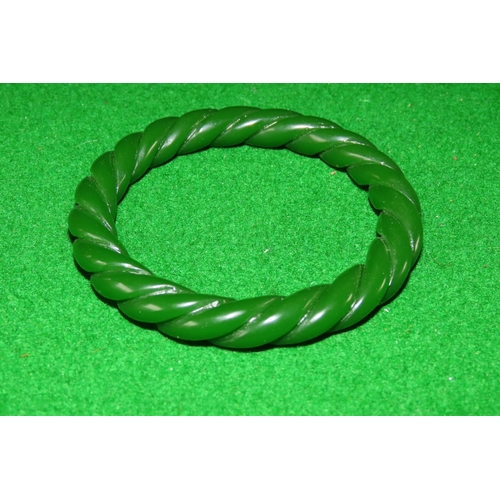 1069 - Carved Apple Green Jade Bangle Twist Motif Design 6cm Inner Diameter