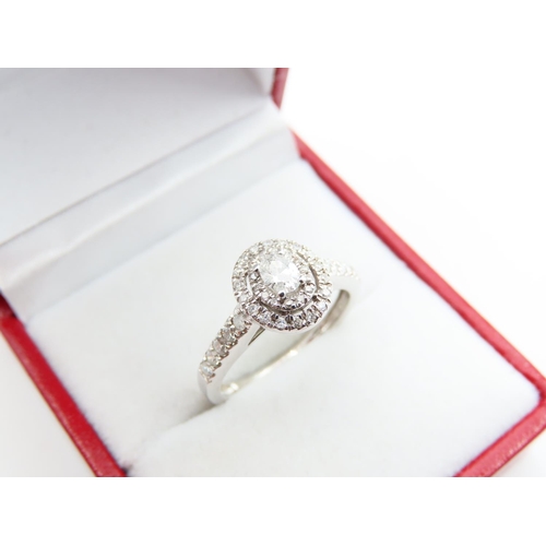 185 - 18 Carat White Gold Diamond solitaire Ring Halo Set with Further Diamond Decorated Shoulders Attract... 