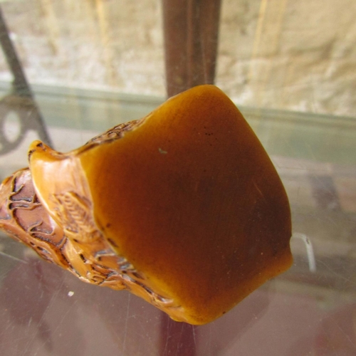 584 - Carved Amber Form Scroll Weight Approximately 6cm Wide