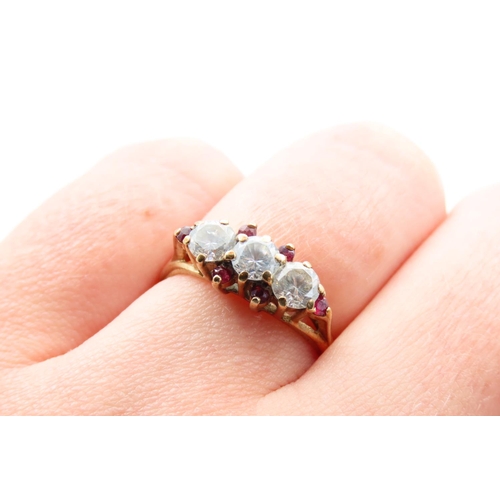 92 - Pale Sapphire and Ruby Set Three Stone Ring Mounted on 9 Carat Yellow Gold Band Ring Size L