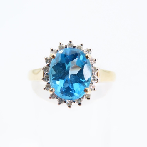 94 - Blue Topaz and Diamond Cluster Ring Mounted on 9 Carat Yellow Gold Band Ring Size N