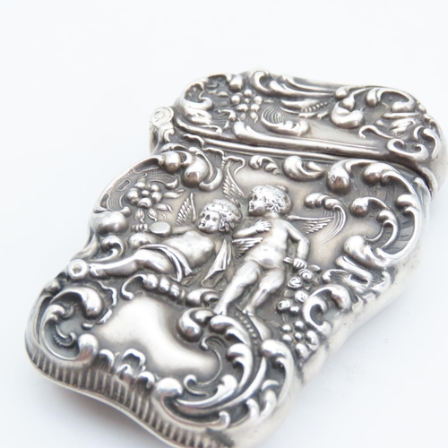 105 - Silver Vesta Case Cherub Motif Hinged Cover Striker Detailing to Base 7cm High x 4cm Wide