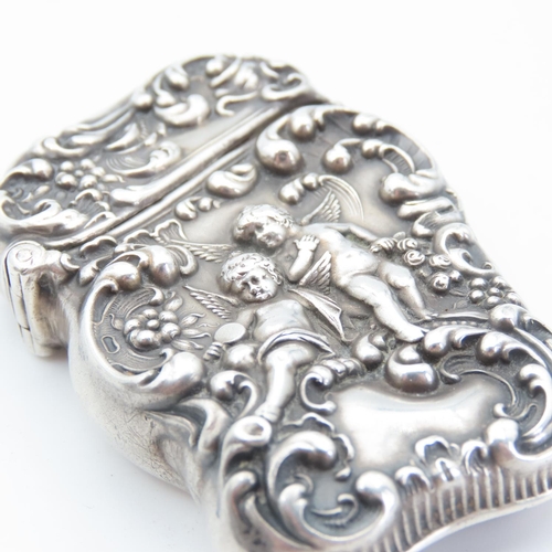 105 - Silver Vesta Case Cherub Motif Hinged Cover Striker Detailing to Base 7cm High x 4cm Wide