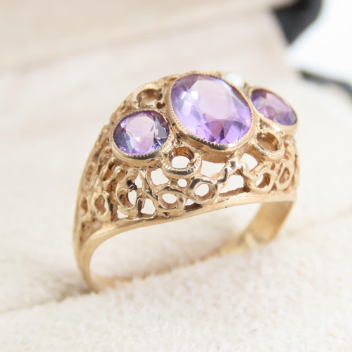 Three Stone Amethyst Ladies Ring Mounted on 9 Carat Yellow Gold Openwork Scroll Setting Ring Size O