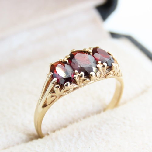 64 - Red Garnet Three Stone Ring Mounted on 9 Carat Yellow Gold Band Size R