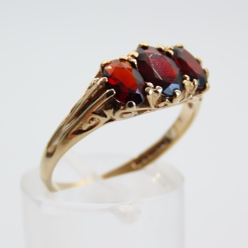 64 - Red Garnet Three Stone Ring Mounted on 9 Carat Yellow Gold Band Size R