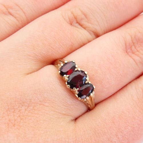 64 - Red Garnet Three Stone Ring Mounted on 9 Carat Yellow Gold Band Size R