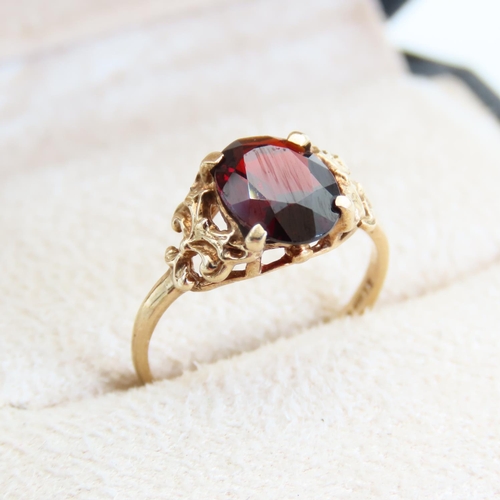 68 - Red Garnet Centerstone Ring Four Claw Set Mounted on 9 Carat Yellow Gold Band Size L