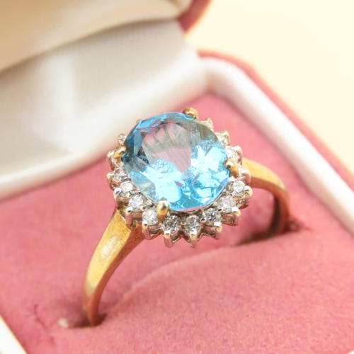 101 - Blue Topaz and Diamond Cluster Ring Mounted on 9 Carat Yellow Gold Band Ring Size U