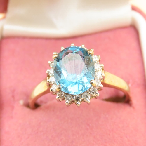 101 - Blue Topaz and Diamond Cluster Ring Mounted on 9 Carat Yellow Gold Band Ring Size U