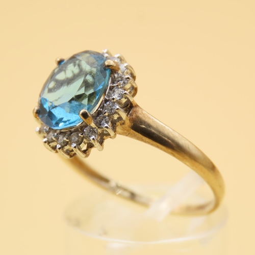 101 - Blue Topaz and Diamond Cluster Ring Mounted on 9 Carat Yellow Gold Band Ring Size U