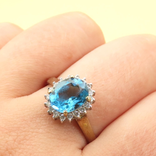 101 - Blue Topaz and Diamond Cluster Ring Mounted on 9 Carat Yellow Gold Band Ring Size U