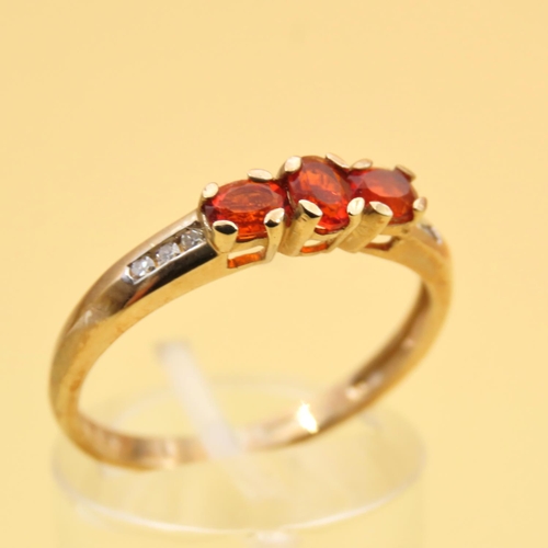 105 - Mandarin Garnet Three Stone with Diamond Mounted on 9 Carat Yellow Gold Band Ring Size R