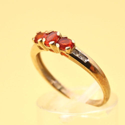 105 - Mandarin Garnet Three Stone with Diamond Mounted on 9 Carat Yellow Gold Band Ring Size R