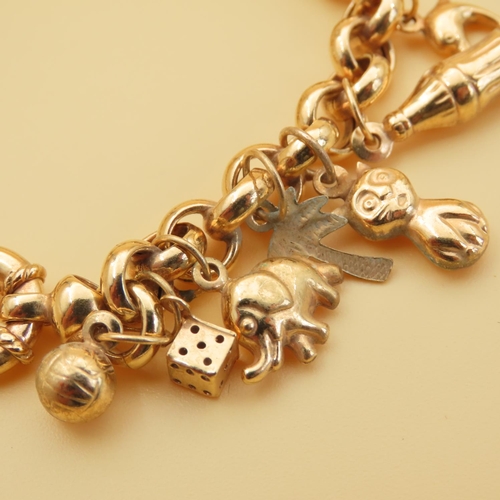 18 - 9 Carat Yellow Gold Charm Bracelet Laden with Various Charms Attractively Detailed 19.5cm Long