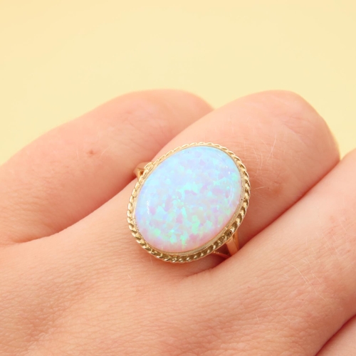 62 - Opal Centerstone Ring Mounted on 9 Carat Yellow Gold Band Ring Size P